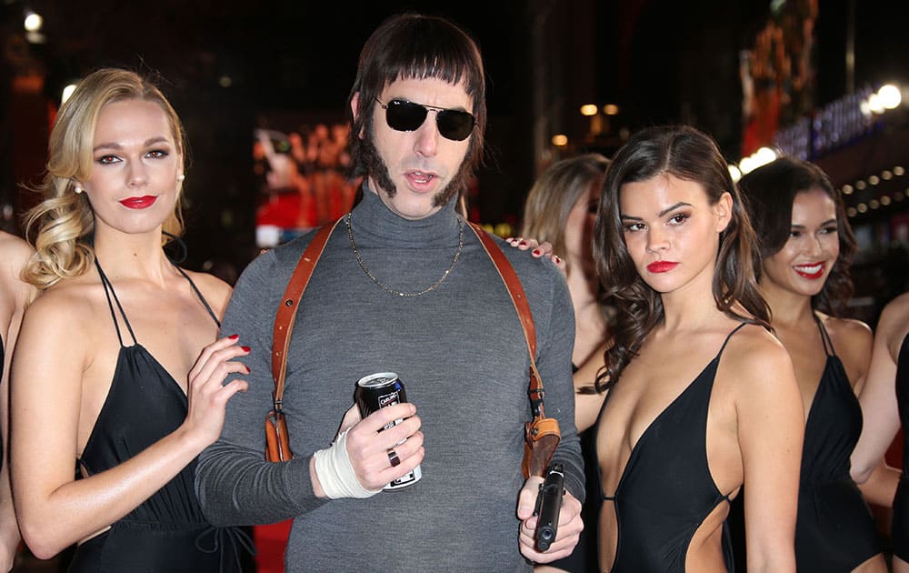 Actor Sacha Baron Cohen, centre, dressed as character Norman 'Nobby' Grimsby arrives at the premiere of the film 'Grimsby' in London.
