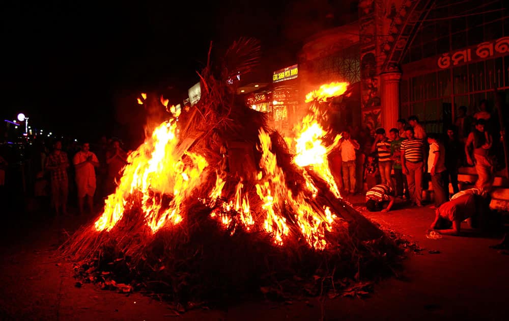 Devotees gather around a bonfire during the Agni Utsav festival in Bhubaneswar.
