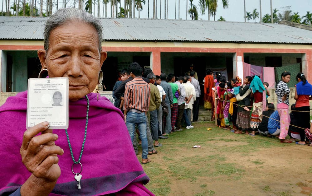 An elderly tribal woman shows voter identity card during the voting for Village Committee elections in Kanchanpur, Tripura.