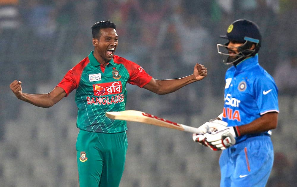 Bangladesh’s Al–Amin Hossain celebrates the wicket of India’s Shikhar Dhawan, right, during the Asia Cup Twenty20 international cricket tournament in Dhaka, Bangladesh.