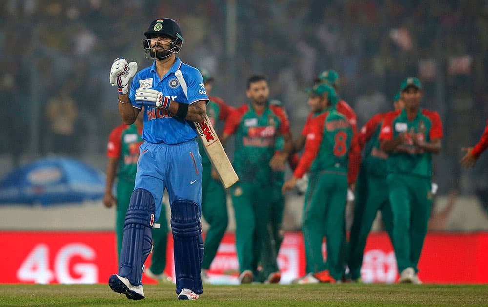  India’s Virat Kohli, left, walks back to the pavilion after his dismissal by Bangladesh’s captain Mashrafe Mortaza during during the Asia Cup Twenty20 international cricket tournament in Dhaka, Bangladesh.