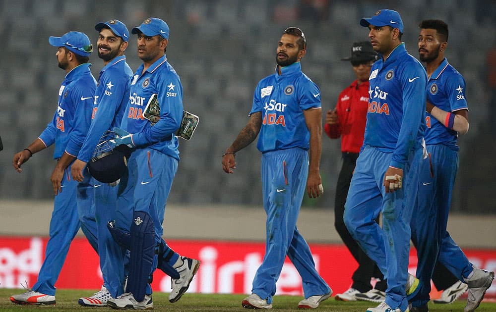 India’s cricket players walk out from the field after winning against Bangladesh during the Asia Cup Twenty20 international cricket match in Dhaka, Bangladesh.