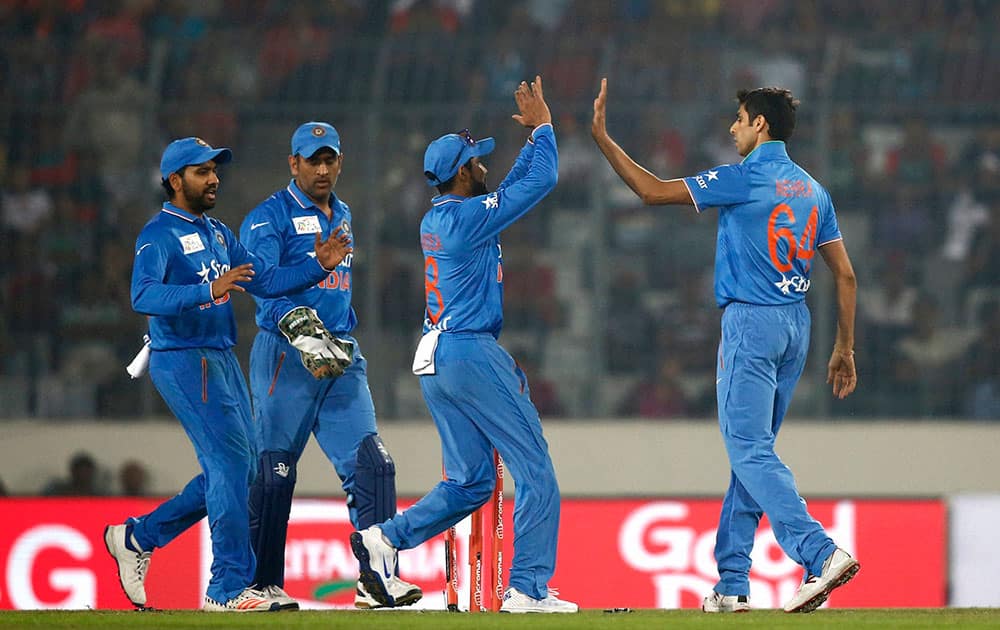 India’s Ashish Nehra, right, celebrates with his teammates after the dismissal of Bangladesh’s Md Mithunduring the Asia Cup Twenty20 international cricket match against Bangladesh in Dhaka, Bangladesh.