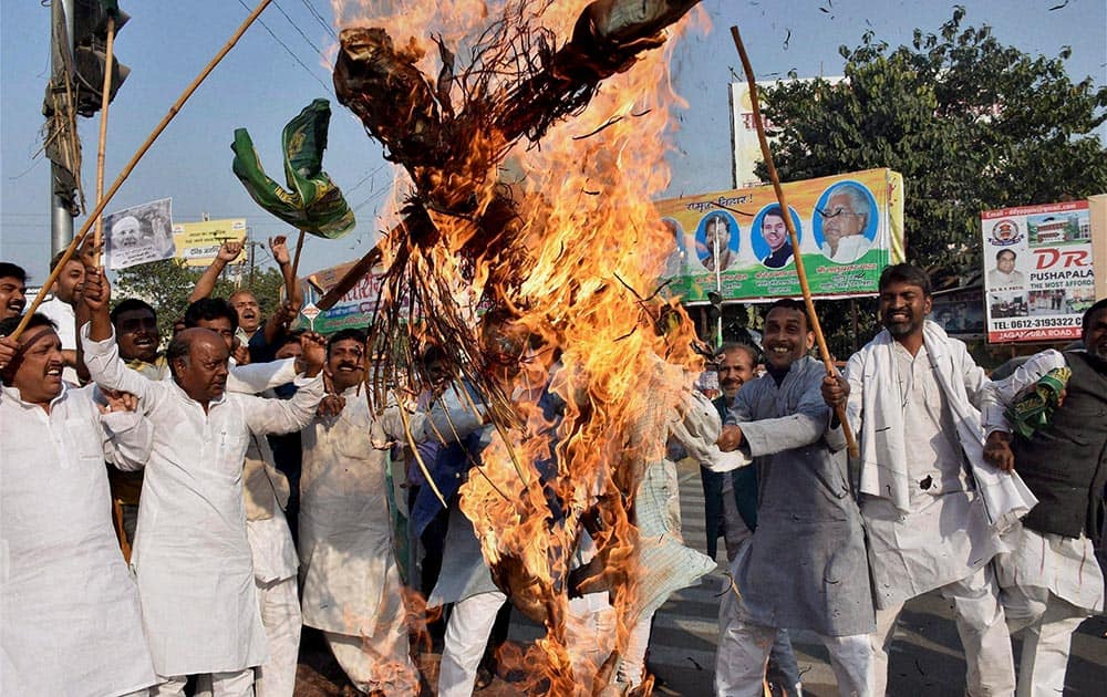 RJD activists burning the effigy of Prime Minister Narendra Modi and Union Rail Minister Suresh Prabhu during protest against Union Rail Budget in Patna.