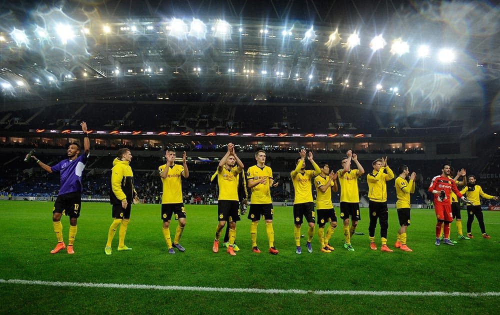 Dortmund players celebrate at the end of a Europa League round of 32, second leg, soccer match between FC Porto and Borussia Dortmund at the Dragao stadium in Porto, Portugal