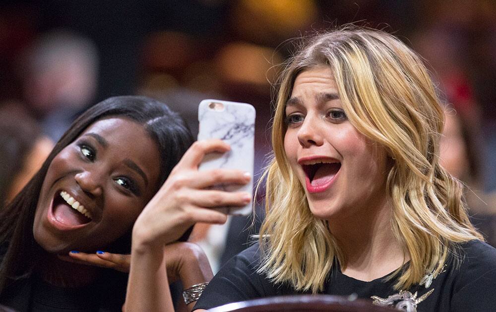 French actress Karidja Toure, left, and French singer and actress Louane Emera pose for a selfie during the 41st edition of the Cesar Ceremony at the Theatre du Chatelet in Paris.