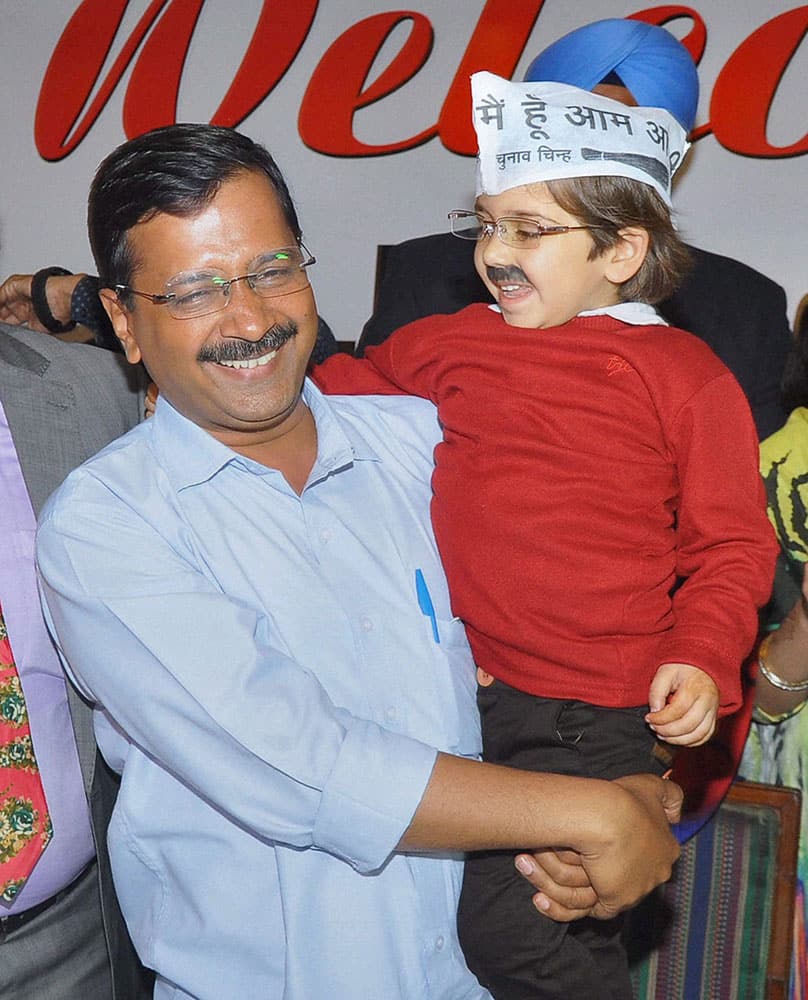 Delhi Chief Minister Arvind kejriwal holds a child dressed as Kejriwal during a meeting with agarwal samaj in Jalandhar.