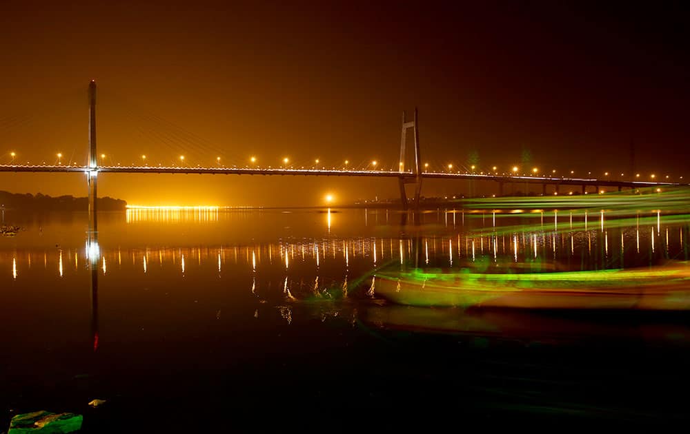 The bridge across the River Yamuna stands illuminated at night in Allahabad, India.