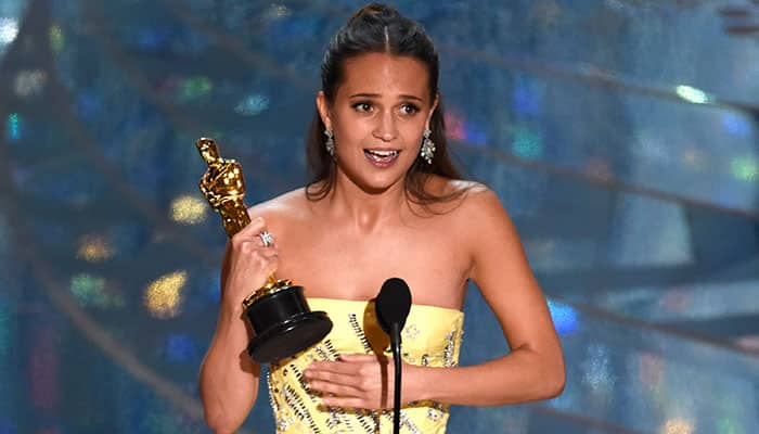 Alicia Vikander accepts the award for best actress in a supporting role for “The Danish Girl” at the Oscars.