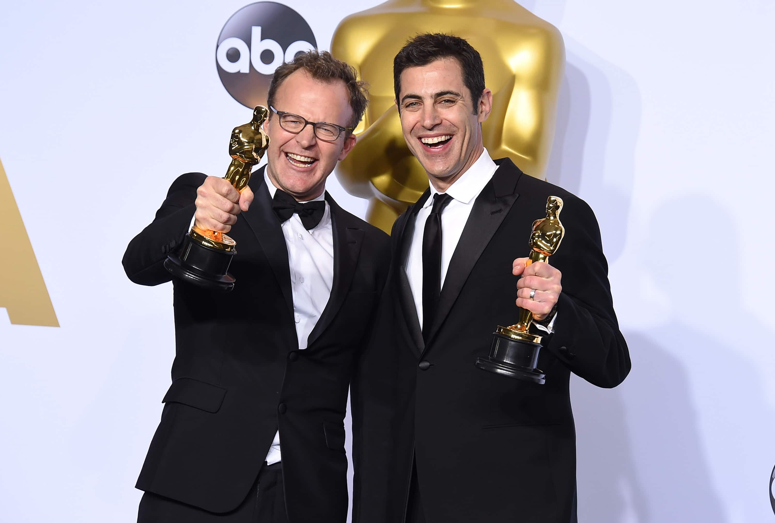 Tom McCarthy, left, and Josh Singer pose with the award for best original screenplay for “Spotlight” in the press room at the Oscars.