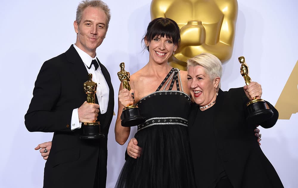 Damian Martin, from left, Lesley Vanderwalt and Elka Wardega pose with the award for best makeup and hairstyling for “Mad Max: Fury Road” at the Oscars.