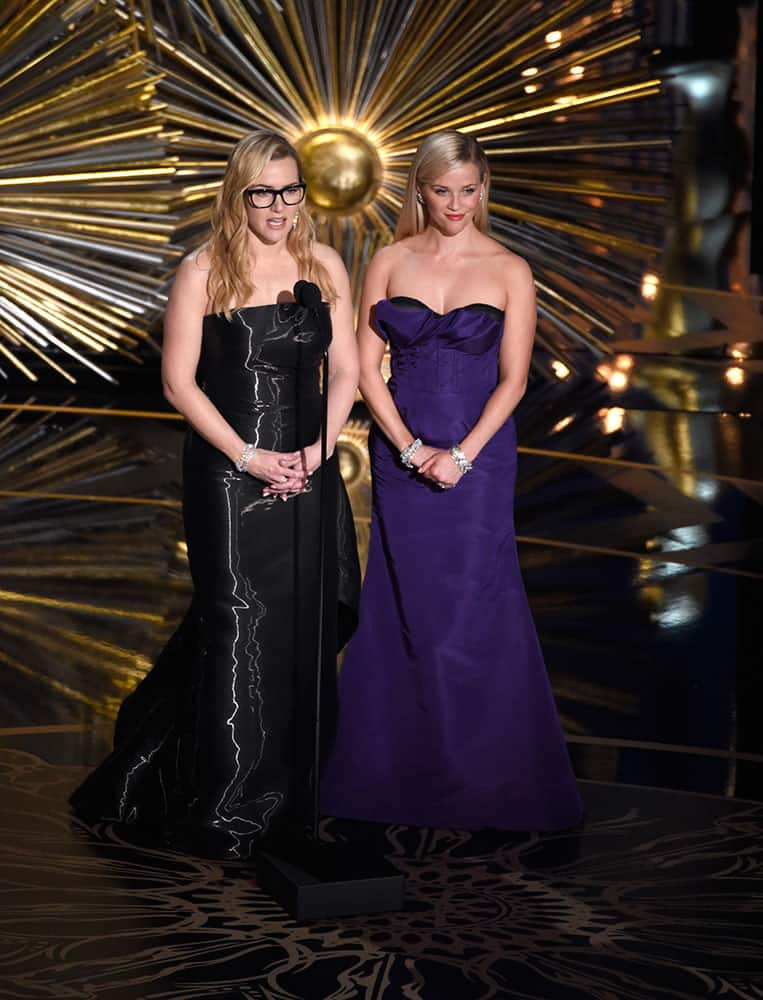 Kate Winslet, left, and Reese Witherspoon speak at the Oscars.