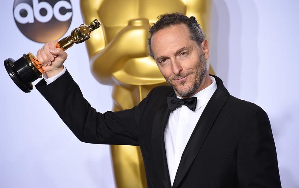 Emmanuel Lubezki poses with the award for best cinematography for “The Revenant” in the press room at the Oscars.