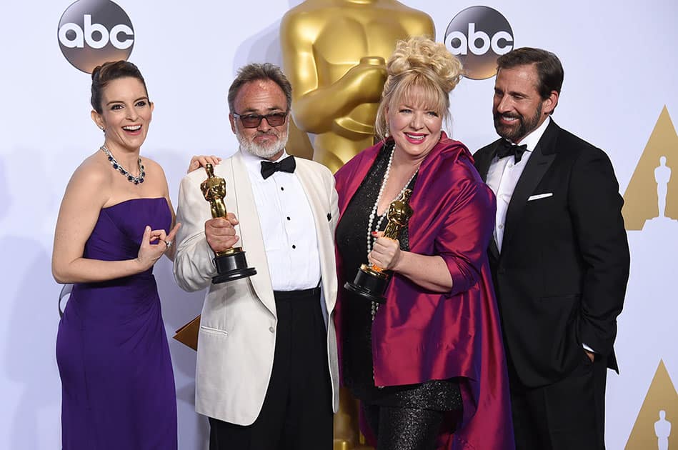 Tina Fey, left, and Steve Carell, right, pose in the press room with Colin Gibson, second left, and Lisa Thompson, winners of the award for best production design for “Mad Max: Fury Road”, at the Oscars at the Dolby Theatre in Los Angeles.