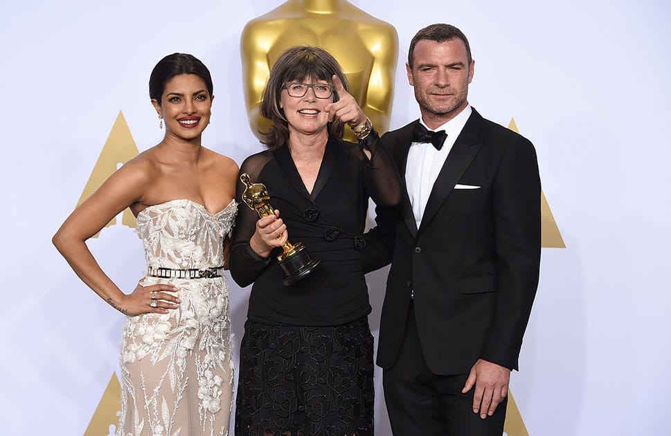 Priyanka Chopra and Liev Schreibe pose in the press room with Margaret Sixel, winner of the award for best film editing for “Mad Max: Fury Road”, at the Oscars at the Dolby Theatre in Los Angeles. 