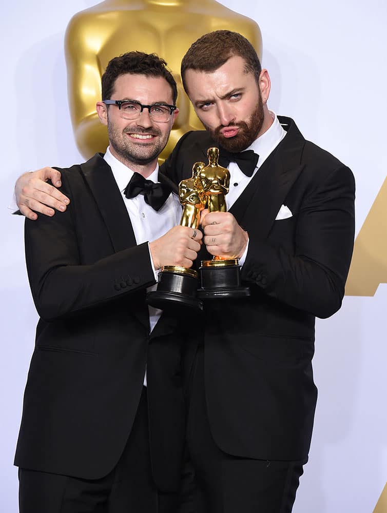 Jimmy Napes and Sam Smith pose in the press room with the award for best original song for “Writing’s On The Wall” from “Spectre” at the Oscars at the Dolby Theatre in Los Angeles.