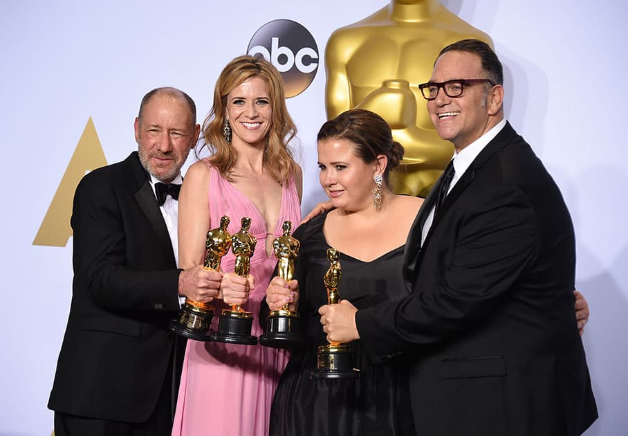 Steve Golin, from left, Blye Pagon Faust, Nicole Rocklin and Michael Sugar, winners of the award for best picture for “Spotlight” pose in the press room at the Oscars at the Dolby Theatre in Los Angeles.