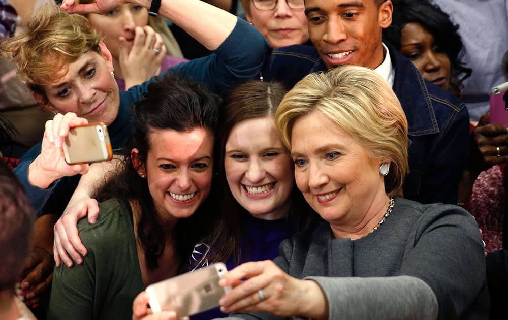Democratic presidential candidate Hillary Clinton takes photos with supporters after speaking at a campaign rally in Norfolk, Va.