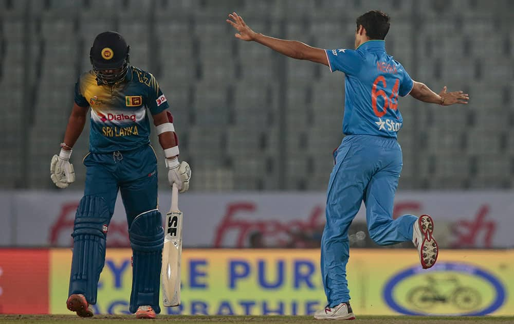 Ashish Nehra reacts after claiming the wicket of Sri Lanka’s Dinesh Chandimal during their Asia Cup Twenty20 international cricket match in Dhaka, Bangladesh.