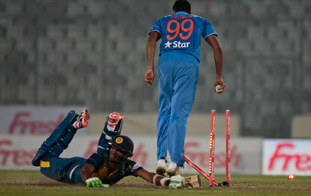 Ravichandran Ashwin breaks the wickets successfully to dismiss Sri Lanka's Dasun Shanaka during their Asia Cup Twenty20 international cricket match in Dhaka, Bangladesh.