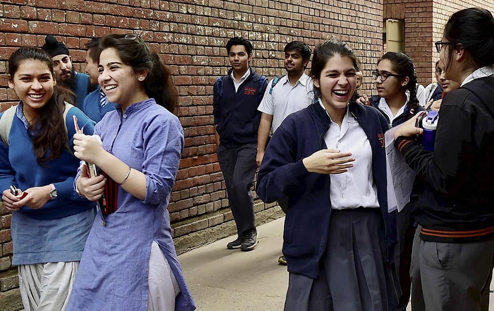 12th standard students discussing after appearing in an examination of the CBSE at a Centre in New Delhi.