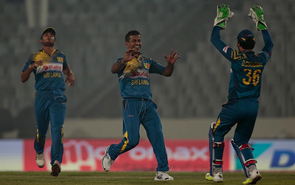 Nuwan Kulasekara celebrates with his teammates after the dismissal of India’s Rohit Sharma during their Asia Cup Twenty20 international cricket match in Dhaka, Bangladesh.