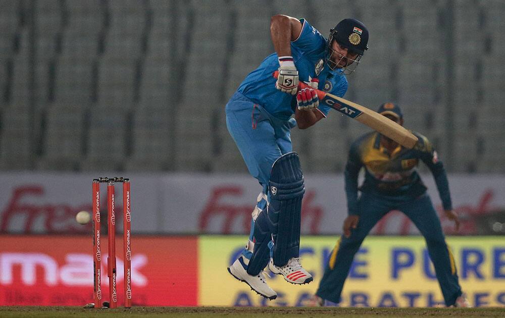 Suresh Raina plays a shot during the Asia Cup Twenty20 international cricket match against Sri Lanka in Dhaka, Bangladesh.