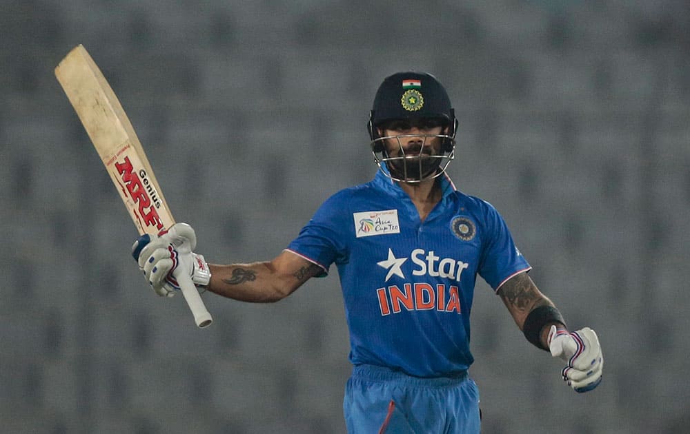 Virat Kohli acknowledges the crowd after scoring fifty runs during the Asia Cup Twenty20 international cricket match against Sri Lanka in Dhaka, Bangladesh.