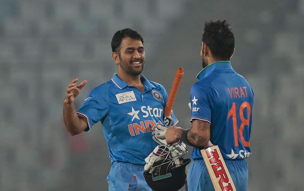 Mahendra Singh Dhoni celebrates with his teammate Virat Kohli after winning the Asia Cup Twenty20 international cricket match against Sri Lanka in Dhaka, Bangladesh.