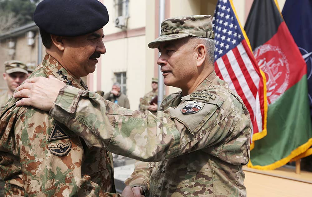 Outgoing Commander of Resolute Support forces and United States forces in Afghanistan, U.S. Army General John Campbell left, talks with Pakistani army chief General Raheel Sharif, during a change of command ceremony in Resolute Support headquarters in Kabul, Afghanistan.
