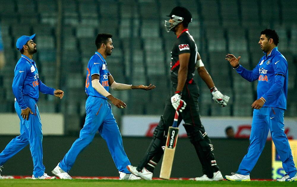 Yuvraj Singh, right, celebrates with his teammates Hardik Pandya, second left, and Virat Kohli after the dismissal of United Arab Emirates’ Muhammad Kaleem, center right, during the Asia Cup Twenty20 international cricket match in Dhaka.