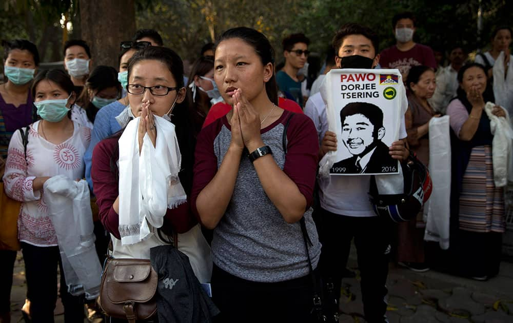 Exile Tibetans pay their respect outside the hospital where Dorje Tsering's body was kept, in New Delhi.