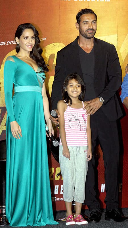 Bollywood actors John Abraham, Nora Fatehi and child artist Divya Chalwad during the trailer launch of their upcoming film ‘Rocky Handsome’, in Mumbai.