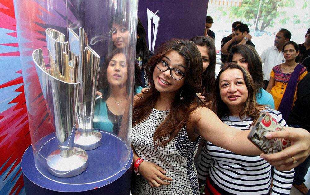 Girls take selfie with ICC T20 World Cup Trophy at event in Thane, Mumbai.