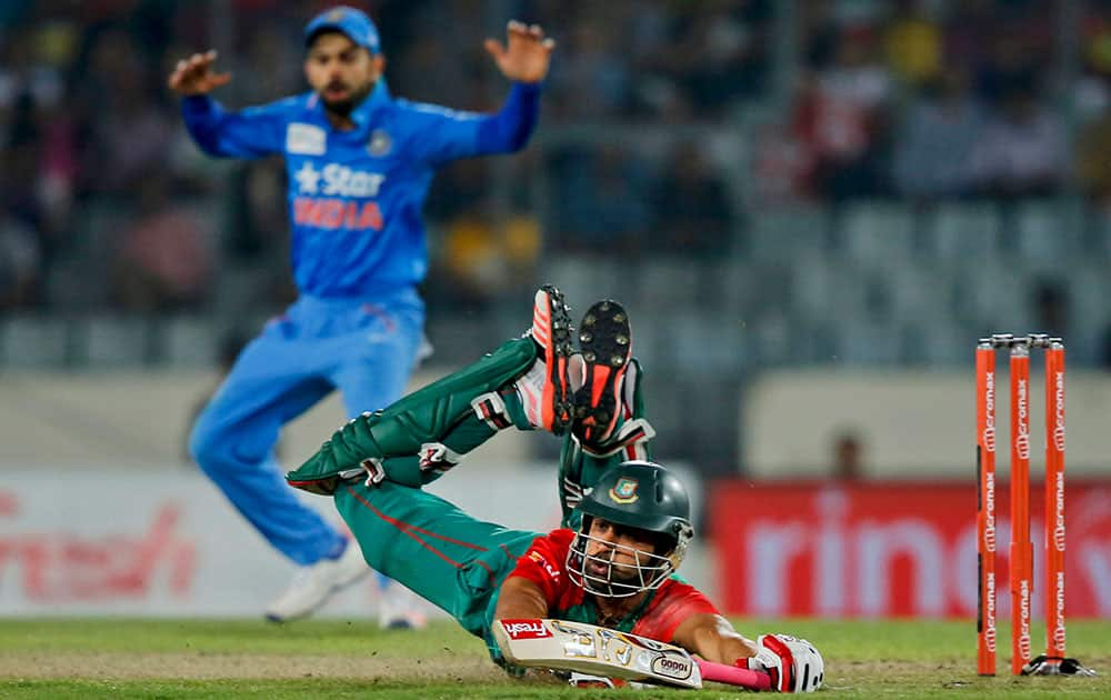 Bangladesh’s Tamim Iqbal, on ground, drives to make his ground during the Asia Cup Twenty20 international cricket final match against India in Dhaka, Bangladesh.