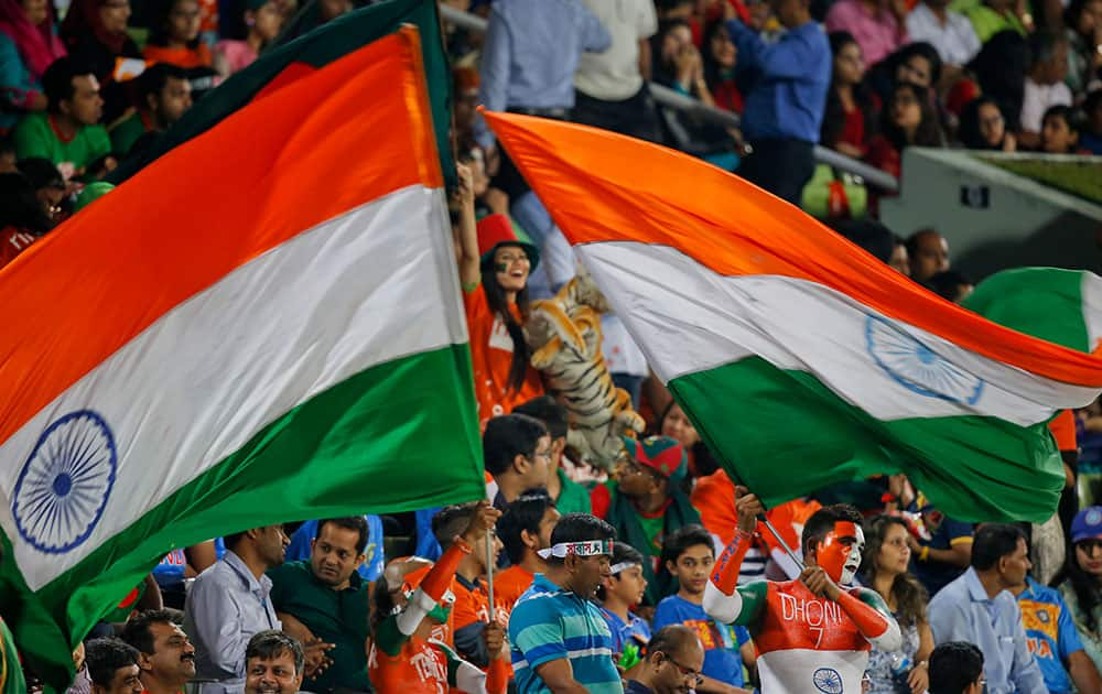 Indian spectators wave their national flags during the Asia Cup Twenty20 international cricket final match between Bangladesh and India in Dhaka, Bangladesh.