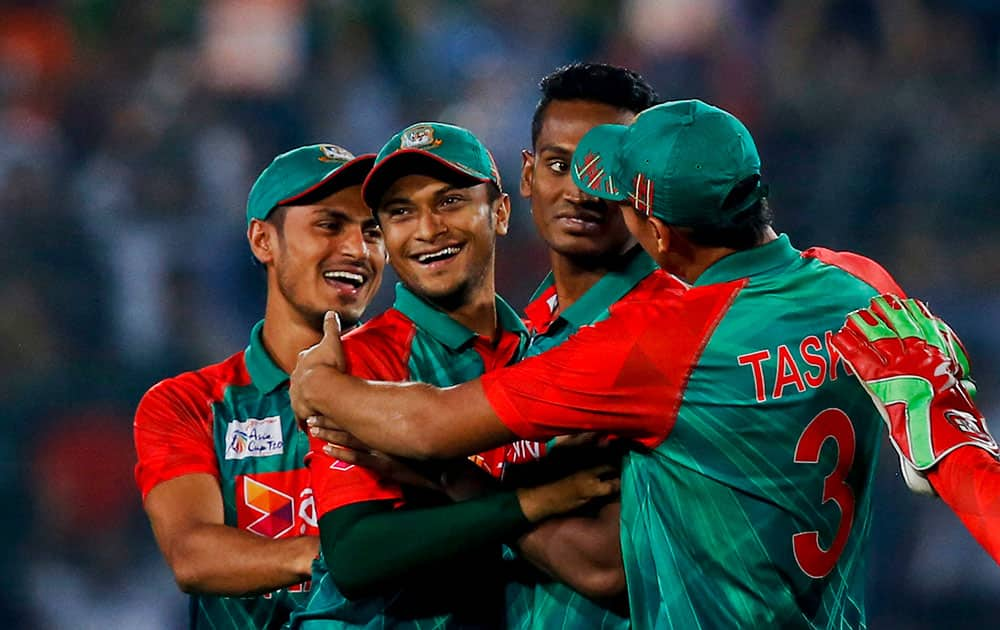 Bangladesh’s Al-Amin Hossain, second right, celebrate with his teammates after the dismissal of India’s Rohit Sharma during the Asia Cup Twenty20 international cricket final match between them in Dhaka, Bangladesh.