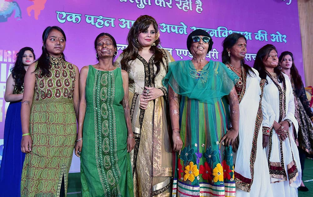 Acid attack victim women walk the ramp with TV actress Amita Nangia during a fashion show organised by an NGO Prerna to mark the International Womens Day, in Bhopal.