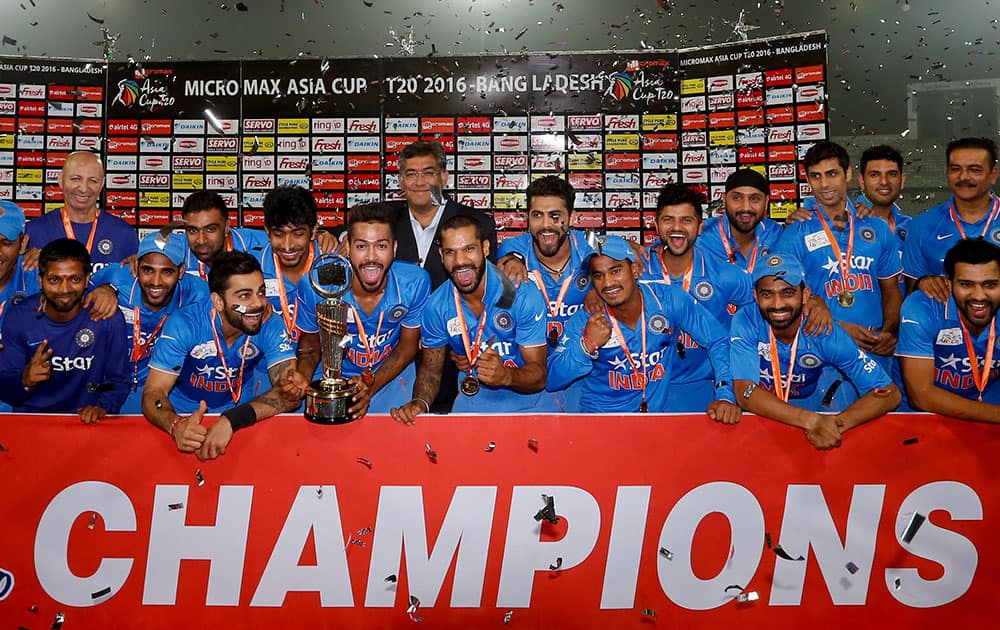 Indian players and support staff pose with the trophy after winning the Asia Cup Twenty20 international cricket final match against Bangladesh in Dhaka, Bangladesh.