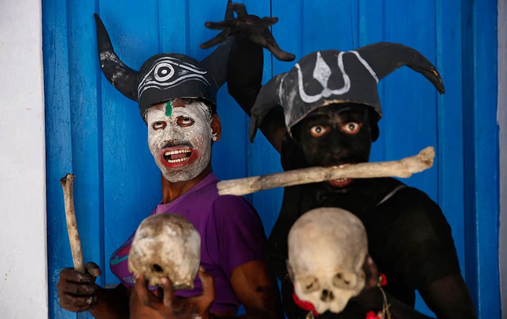 Hindu devotees dressed as demons pose for pictures as they participate in a procession on occasion of Mahashivratri festival in Allahabad,