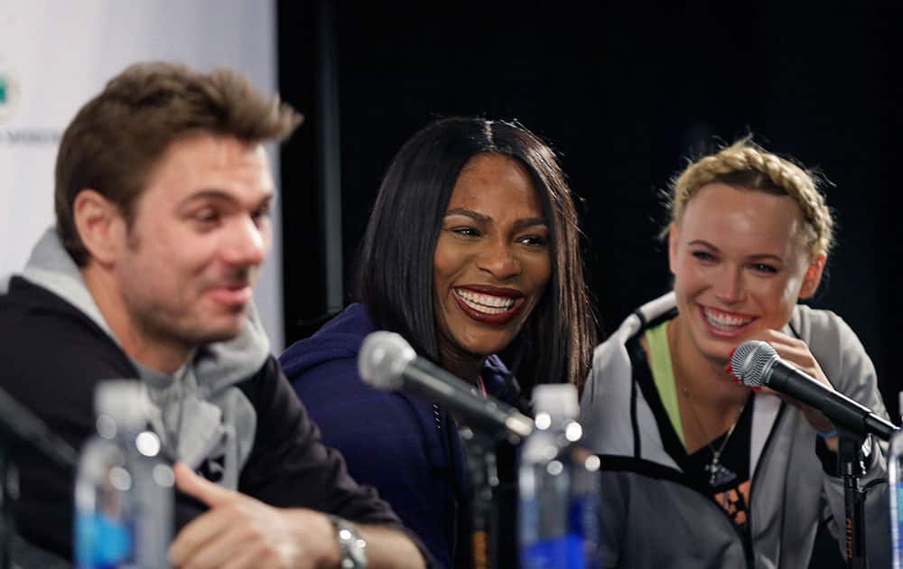 Tennis players Stan Wawrinka, left, Serena Williams, center, and Caroline Wozniacki laugh at a reporters question during a news conference in New York.