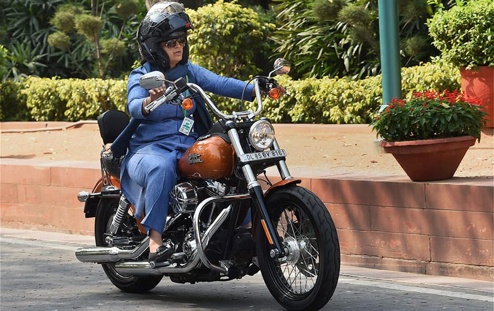 Ranjeet Ranjan, Lok Sabha MP from Supaul (Bihar), rides a Harley Davidson bike at Parliament in New Delhi on International Womens Day.