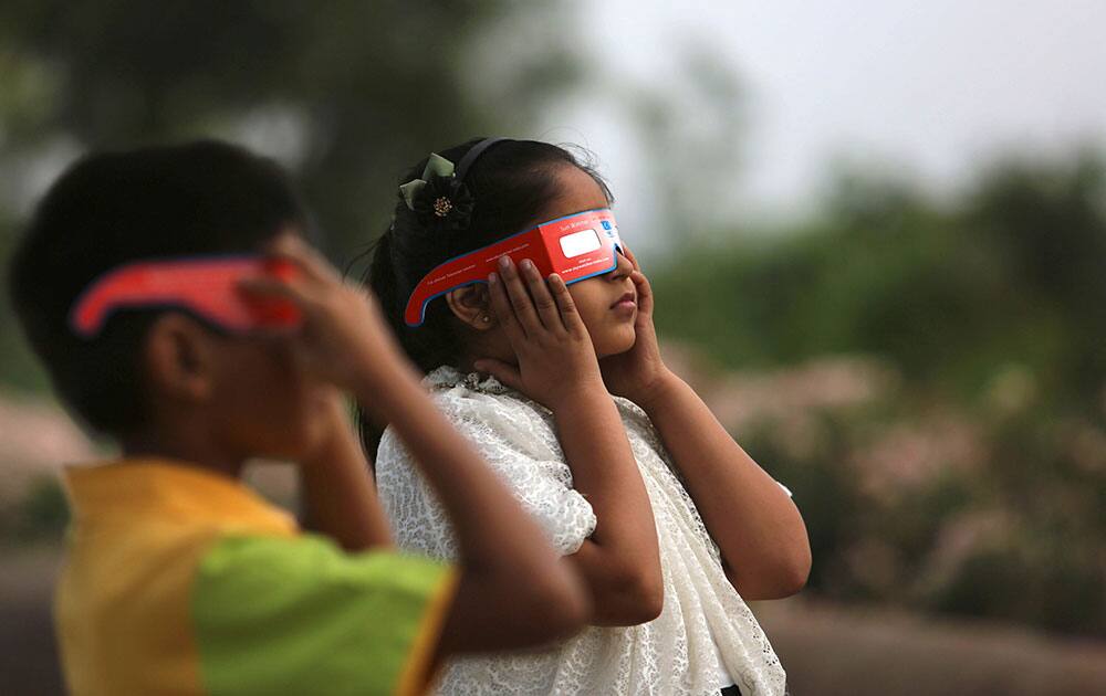 Children watch a partial solar eclipse in Hyderabad.