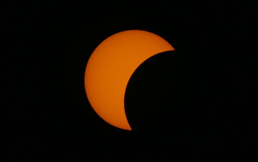 A partial solar eclipse occurs as seen from Taguig city, east of Manila, Philippines.