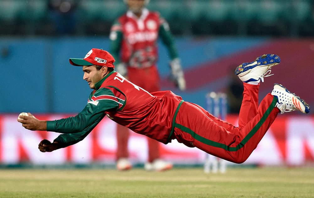 Oman Player Zeeshan Maqsoodof takes catch of Ireland batsman R Stirling during their ICC T20 World cup match in Dharamshala.