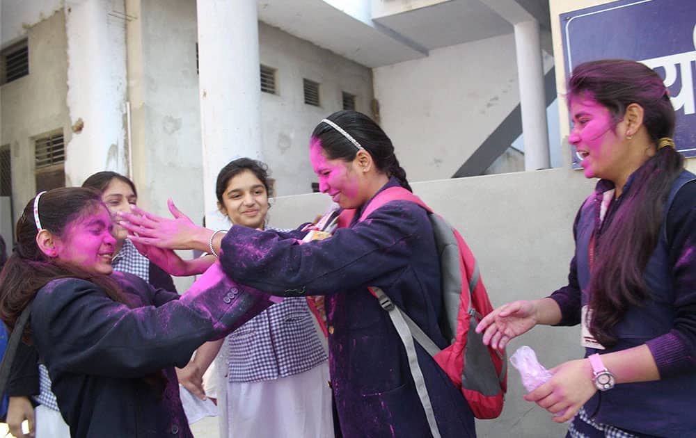 High School students celebrate with colours after the end of UP Board examinations in Meerut.