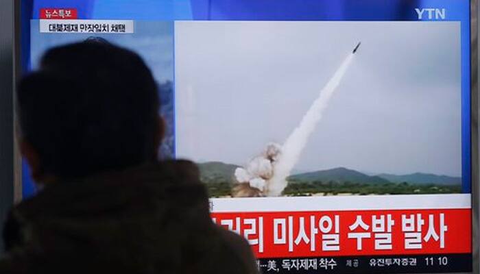 North Korea fires missiles, says will liquidate South assets