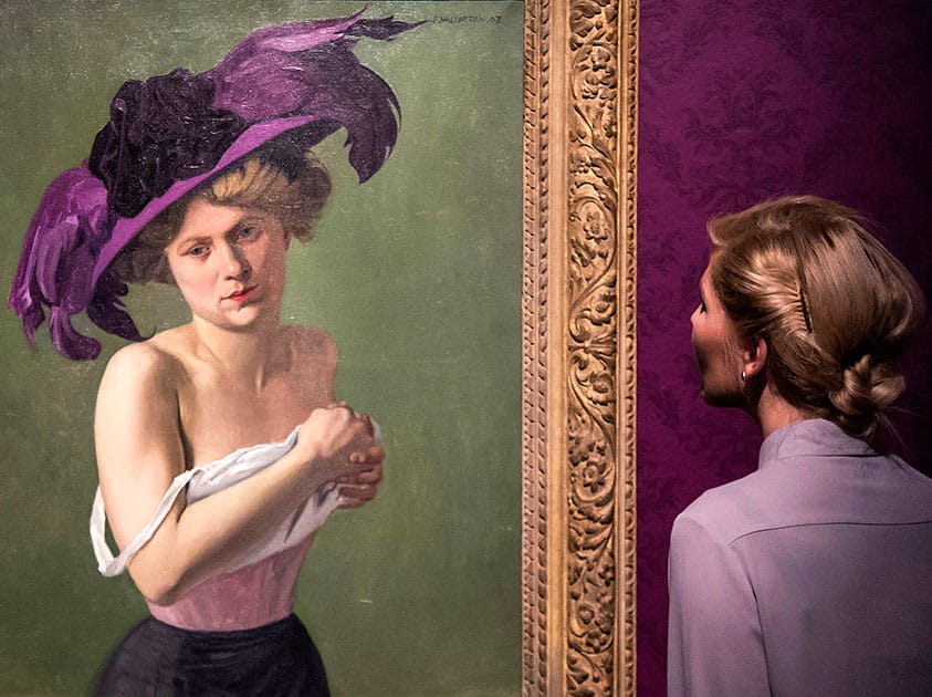 A woman looks at the painting 'The purple hat' (1907) by Felix Vallotton (1865-1925) during the preview of the exhibition 'Magic of the moment - Van Gogh, Cezanne, Bonnard, Vallotton, Matisse.