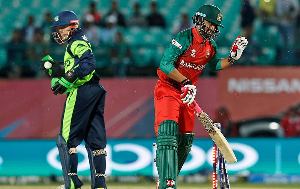 Bangladesh's Tamim Iqbal, right, reacts after the ball hit his stumps as Ireland's wicketkeeper Niall O'Brien looks on during their ICC World Twenty20 2016 cricket tournament at the Himachal Pradesh Cricket Association (HPCA) stadium in Dharmsala.