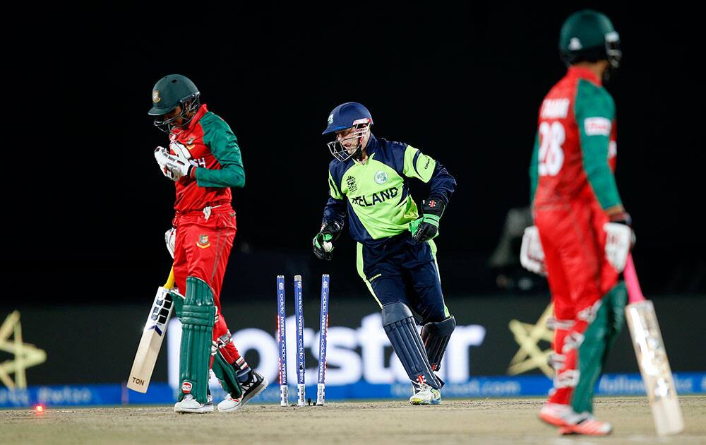 Ireland's wicketkeeper Niall O'Brien, centre, dismisses Bangladesh's Soumya Sarkar, left, during their match at the ICC World Twenty20 2016 cricket tournament at the Himachal Pradesh Cricket Association (HPCA) stadium in Dharmsala.